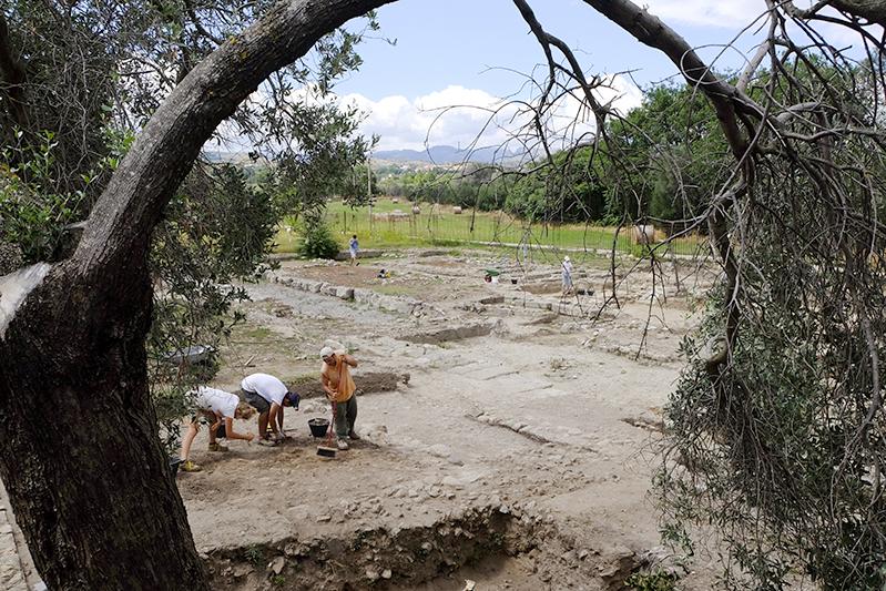 Tre archeologi impegnati in uno scavo