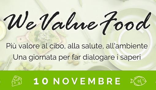 We Value Food. Più valore al cibo, alla salute, all'ambiente titolo dell'evento sullo sfondo di un tavolo con delle verdure